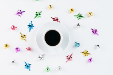 coffee cup surrounded by Christmas ornaments