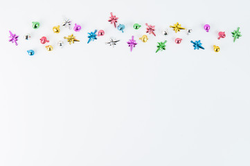 little colorful christmas ornaments on a white background with lots of copyspace
