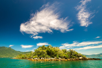 Fototapeta premium Small Island Near Brazilian Coast, With Turquoise Water and Clouds in the Blue Sky