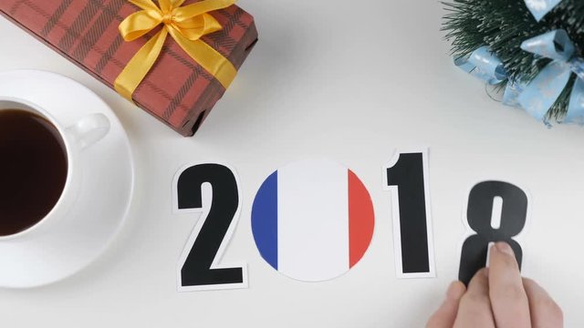 Illustration, new year, male hand changes the year from 2017 to 2018, France flag, cauntry ball.