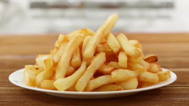 elicious french fries on a plate - camera moves around it