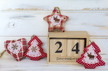 Christmas Ornaments and Wooden Calendar with Date on White Wooden Background. Christmas Concept