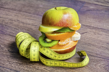 Creative Healthy Apple Burger with Fruits and Measuring Tape .Healthy Eating Concept