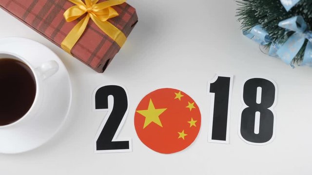 Illustration, new year, male hand put on the table an China flag, cauntry ball, 2018