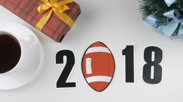 Illustration, new year, male hand put on the table an football, 2018
