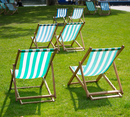 group of green and white Deck Chairs on a lawn in the UK
