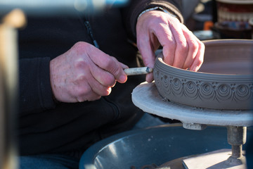 man with tool manufacturing pottery