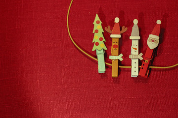 Christmas clothespins on the red background