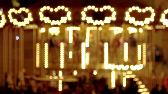 Carousel with lights shaped heart. Blurred carousel.