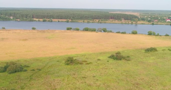 Arable landon Volga river aerial view from flying quadcopter over forest. Landscape panorama. Beautiful nature. Horizon in the background of fields of meadows and sky.