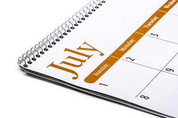 Desk top calendar July close up on white background