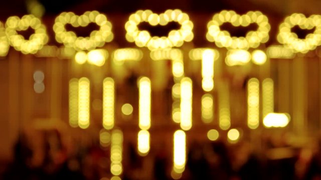 Bright blurred carousel. Lights shaped heart.