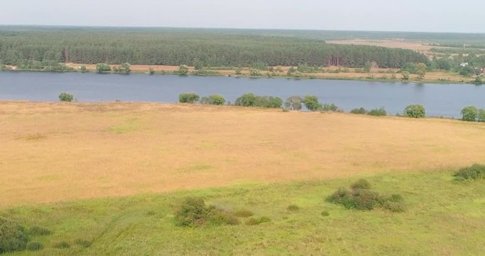Arable landon Volga river aerial view from flying quadcopter over forest. Landscape panorama. Beautiful nature. Horizon in the background of fields of meadows and sky.