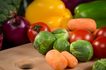 Closeup of assorted fresh vegetales on cutting board