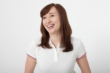 Smiling woman with healthy teeth in white T-shirt isolated on white. Copy space