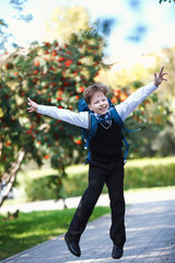 Little boy with a backpack go to school.
