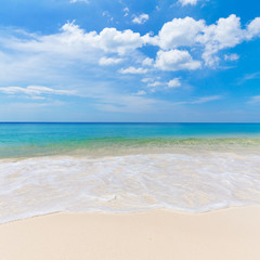 Sunny tropical beach with white sand and blue sky
