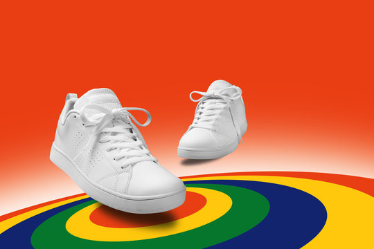 Pair of White sneaker composition like dancing on color full spin cicle  background with clipping path