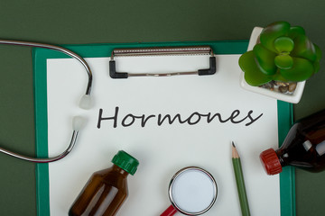 Doctor workplace - red stethoscope, medical bottles and clipboard with text 