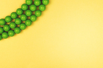 Texture of colored yellow, gold and green beads