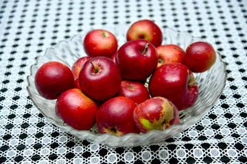 Naklejka na ściany i meble Red organic apples on a big glass plate.Horizontal.