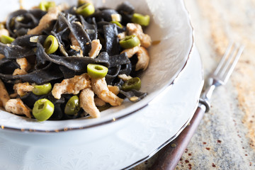 Black ink pasta with chicken and green olives