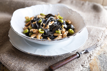 Black ink pasta with chicken and green olives