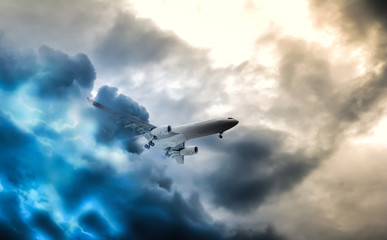 Fototapeta na wymiar Passenger aeroplane throught turbulent thunderstorm and lightnings