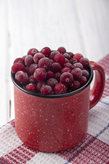 Frozen cranberries in a red cup