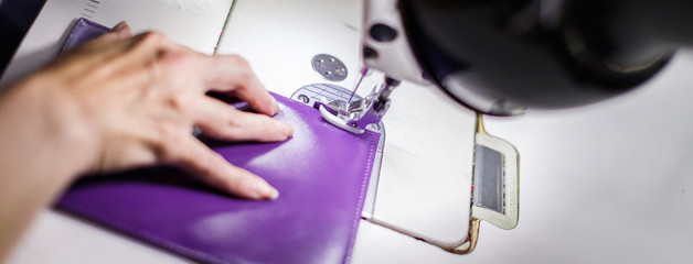 female hands stitching a purse