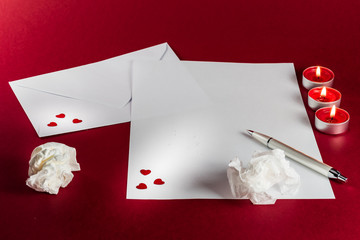 Valentines love letter writing setup, with envelope, paper, red hearts and candles - 182741705
