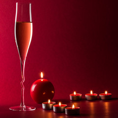 Valentine mood with a glass of champage and candles - 182741974