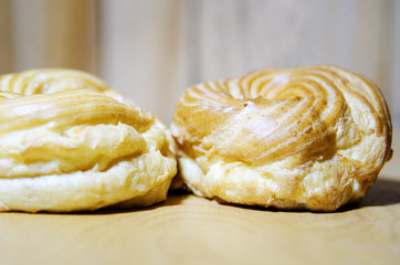 Cakes with cream lie on the table. Close-up, selective focus.