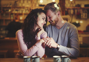 Young attractive couple on date in bar