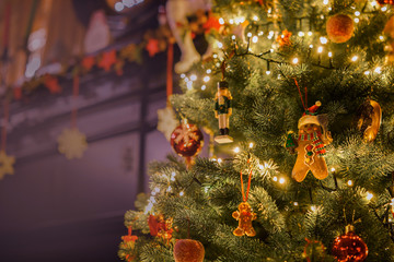 Toys on a Christmas tree close-up background of a fireplace in the interior of the house.