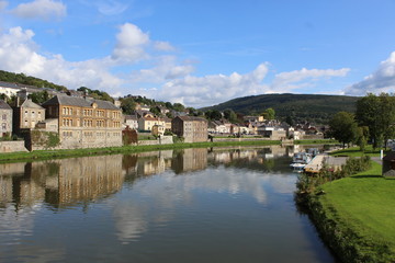 French city with river and old buildings