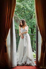 Fototapeta premium bride stands near the window