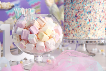 Glass bowl with marshmallows on buffet table