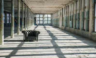 Foto op Plexiglas Stoel in een verlaten fabriek © Gatis