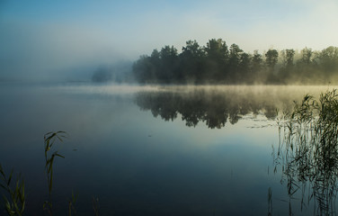 Calm lake foggy morning