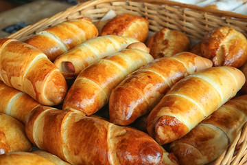 Fresh tasty bakery products in wicker basket