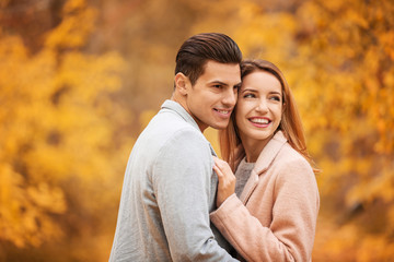 Fototapeta premium Young couple in park on autumn day