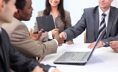 handshake business partners at a business meeting