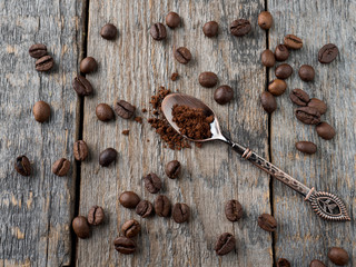 Coffee background. Grain coffee on a rustic wooden background.
