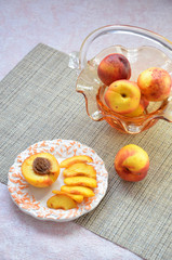 Fresh peaches, Peach close up fruit background, peach on a table on a plate of a beautiful vase in the shape of a basket background,sweet peaches, group of peaches,sliced peaches, peach slices