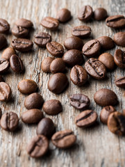 Coffee background. Grain coffee on a rustic wooden background.