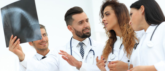 group of medical workers looking at patient's x-ray film