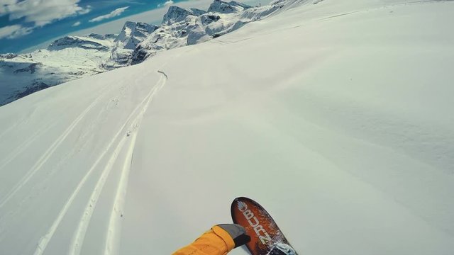Point of view shot of Actionsportlers snowboarder while freeride in remote area in Europe Alpes