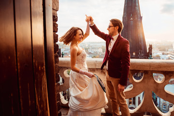 groom in a luxurious costume dancing with his beloved on the bal