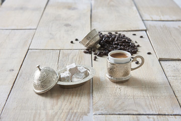 Turkish coffee in copper coffee pot on wooden background style